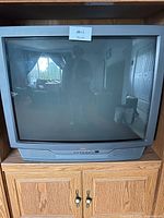 Front view of Sears 32-inch CRT TV within cabinet