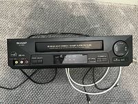 Front view of Sharp VC-H620 VCR showing controls and branding