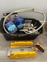 Overall lot with miter box, saw, hose, bulb boxes and basket of tools