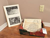 overall view showing box of maps and two prints