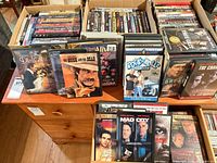 Overview of dresser top with two boxes and front-facing DVD cases