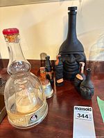 Group shot showing Bols bottle, large black Inca decanter, mini bottles