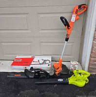 All three corded electric tools staged together in front of garage door