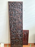 Front view of tall carved door panel with relief motifs