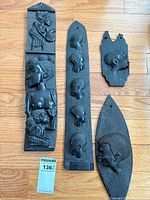 All five plaques arranged on floor for size comparison