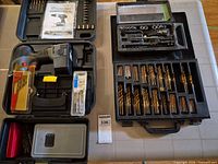 Overall view showing cordless drill in case, drill bit case, additional packaged bits
