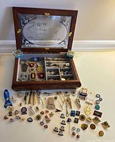 overall view of open jewelry box and contents spread on table