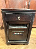 Full front view of cabinet heater showing drawer, vent, control panel
