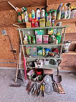 Full view of shelving with garden chemicals, long-handled tools and hand tools