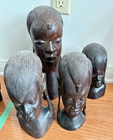 Front view of all four carved wood busts