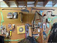 Overall view of pegboard lot with tools and packaged accessories