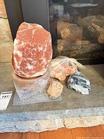Overall lot showing large salt crystal on cylindrical base, bag of rock fragments, wrapped cord, small chunk