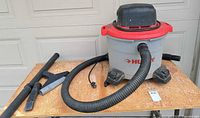 Husky shop vacuum with hose, extension wand and floor nozzle visible