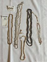 Overview of necklaces, earrings on card and lot label