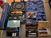Group shot of rotary tool, drill, accessory kits, knife and router bit sets