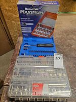 All three sets stacked: router bit set box, blue clamshell with screwdriver bits, clear Jobmate rotary tool accessory case
