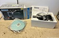 Boxed Shopmate sander with accessories laid out