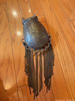 Full view of oval bronze/brass pouch with chain fringes