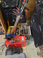 Overview showing clamps, biscuit joiner on red toolbox, plastic toolboxes
