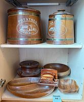 two wood canisters labelled Potatoes and Onions, several wood bowls below