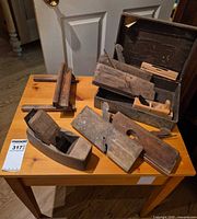 overview of all wooden hand planes on table