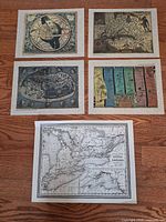 Group shot showing all five map prints on floor