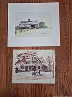 Both prints displayed on wooden floor