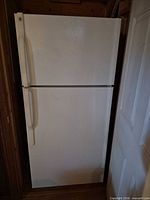 Front view of white GE top-freezer refrigerator