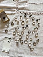 Group shot showing entire assortment of rings with lot tag