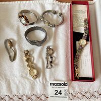 Group view of five wristwatches and two bracelets