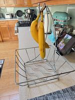 Banana hanger holding bananas on kitchen counter