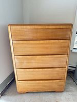 Front view of four-drawer dresser in light honey veneer