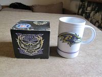Mug out of box beside boxed identical mug