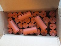 Box interior showing multiple terracotta curling rods neatly stacked