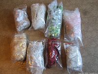 Eight bagged appliques laid out