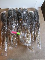 Seven sealed packages braided hair extensions on countertop
