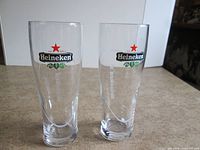 Front view of both Heineken beer glasses showing logos