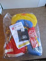 Stohlquist infant life jacket sealed in plastic with paperwork visible