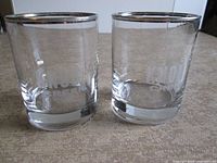 Pair of Knob Creek etched glasses standing side by side