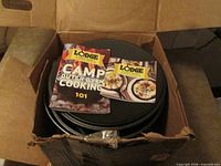 Dutch oven in original box with booklets visible