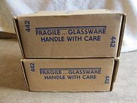 Two stacked sealed Princess House 442 cartons