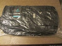 Suitcase in original plastic showing logo and general appearance