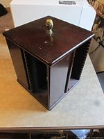 overall view showing wood CD rack with top finial and four sides