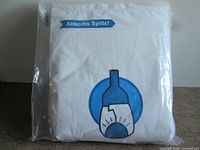 Front of sealed package showing WineDiaper sleeve graphic and Absorbs Spills text