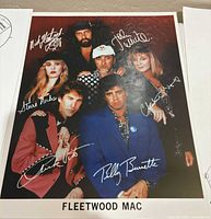Color promo photograph with band members and printed signatures labeled "FLEETWOOD MAC"