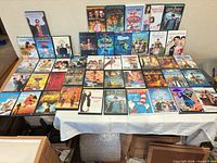 Full lot of 45 DVD cases laid out on table