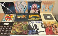 All 12 album covers laid out in three rows of four
