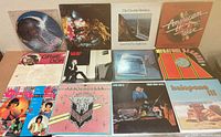 All 12 record covers laid out in three rows, showing titles and artwork