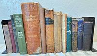 Front view of all 14 books between metal bookends