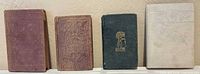 Front covers of all four miniature books lined up
